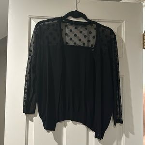 Black cardigan with shear polka dot sleeves and top.